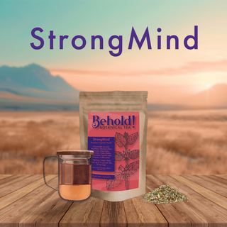 Bag of cognitive health promoting tea next to a glass of tea and organic botanicals